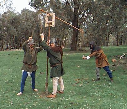 John and Russell get ready to power the treb, while Dick holds the sling.... photo by Kate Miners